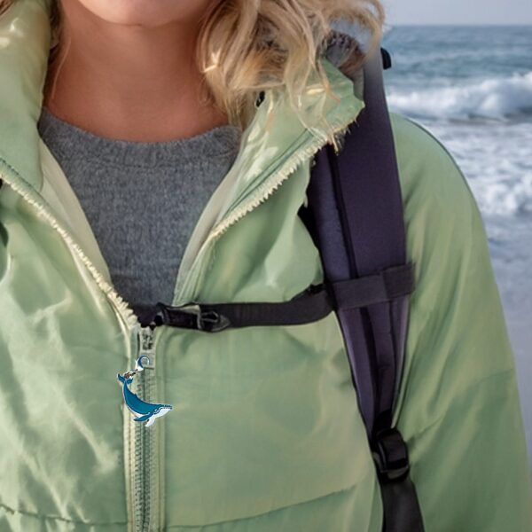 hiker wearing humpback whale charm