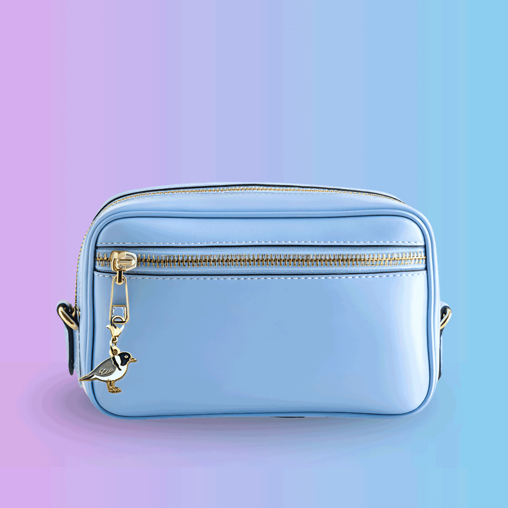 hooded plover charm attached to small bag