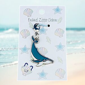 humpback whale charm attached to beach themed packaging.