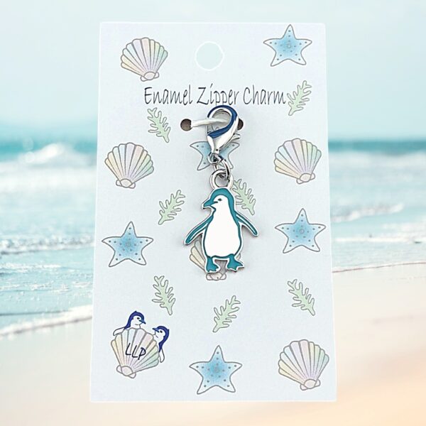 penguin charm teal attached to beach themed packaging