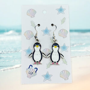 penguin earrings on beach themed card