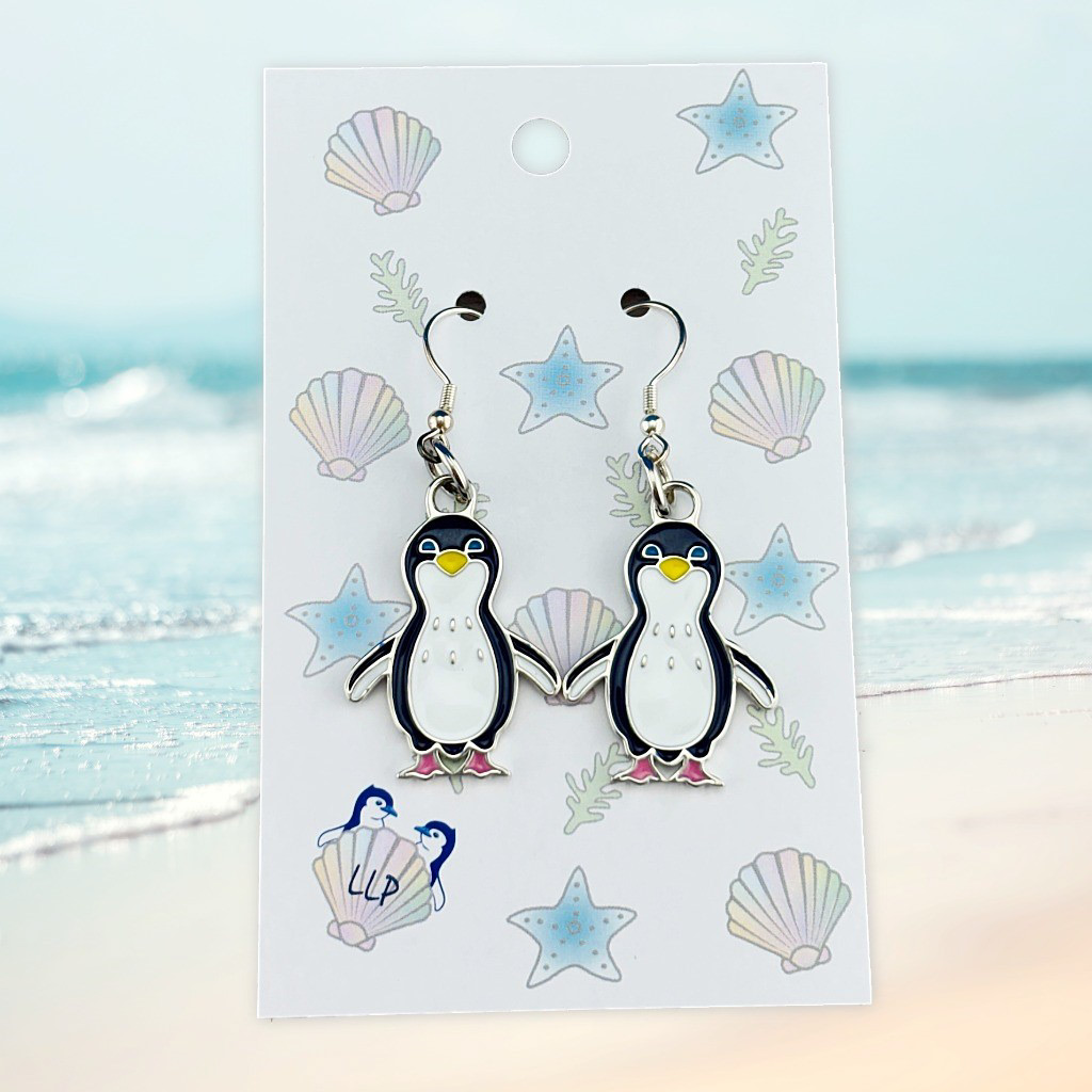 penguin earrings on beach themed card